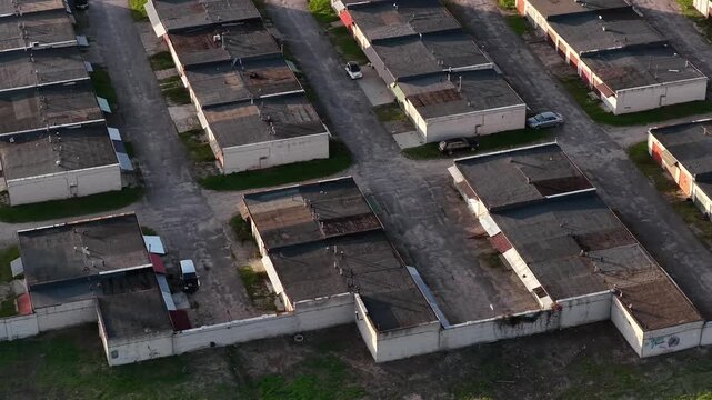 Aerial view of a complex of flat-roofed garages with parked cars in Kaisiadorys, Kaunas County, Lithuania.