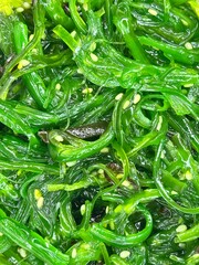 Healthy green wakame seaweed salad with sesame seeds © Nadiia