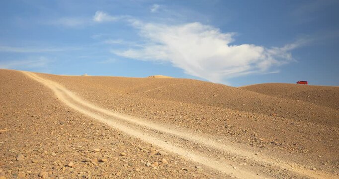 Road through rocky desert and sandy desert, red minibus, Atacama Desert, Chile