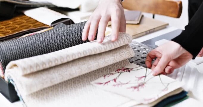Interior Designer Browsing Through Textile Samples and Fabric Swatches for Home Decor Project