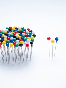 Conceptual image of standing out from the crowd with push pins