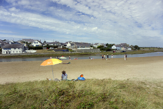 People Relaxing on the Sandy Beach at Aberffraw Estuary, Anglesey