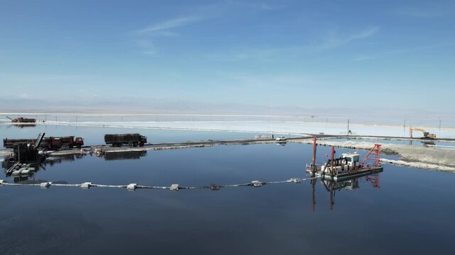 Aerial view of salt mining equipment and trucks on Chaka Salt Lake in Qinghai China