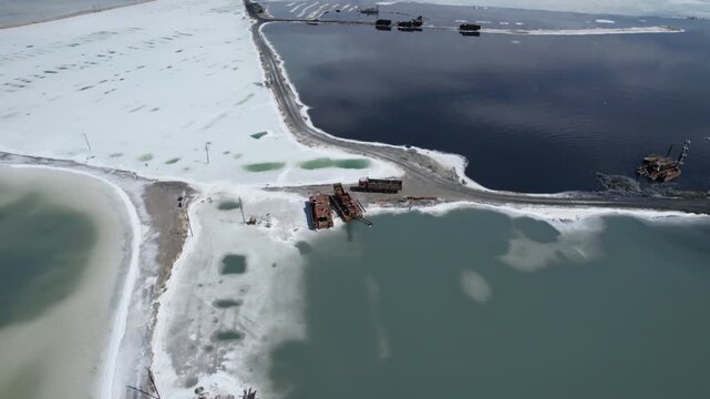 Aerial view of Chaka Salt Lake in Qinghai China with salt harvesting equipment and turquoise water
