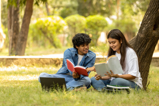 Indian college Student  studying at park