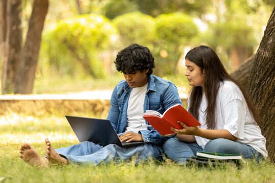 Indian college Student  studying at park