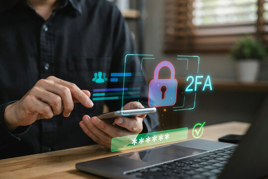 Person using laptop with digital two factor authentication security lock overlay for safe account access and data protection.
