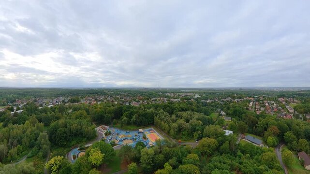 FPV drone flight reveals Koupark family outdoor sports and recreation park surrounded by parkland trees in Ostrava-Radvanice,