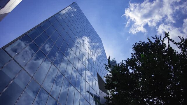 A timelapse of cloud reflecting the office building sunny day wide shot