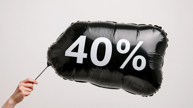 A black foil balloon with 40% printed on it is held by a hand, signifying a sale or discount.