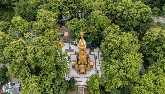 Aerial view of an iconic Buddhist pagoda of Phra That Doi Mae Ya Mon temple a prominent temple located in Chiang Khong district, overlooking the serene Mekong river.