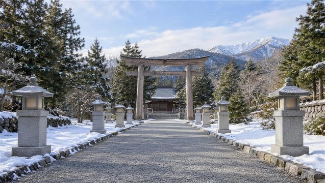 雪をかぶった石灯籠が並ぶ神社の参道と鳥居