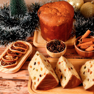 Christmas panettone with candied fruit and raisins featured on a festive table, with slices cut to reveal the soft crumb.