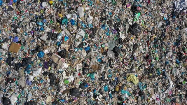 Aerial view of massive landfill site filled with piles of plastic waste and debris in Russia.