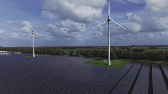 Aerial view of wind turbines and solar panels in a field in t Zand, North Holland, Netherlands.