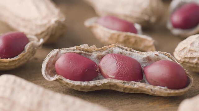 Closeup view of fresh peanuts on wooden table. Macro shot