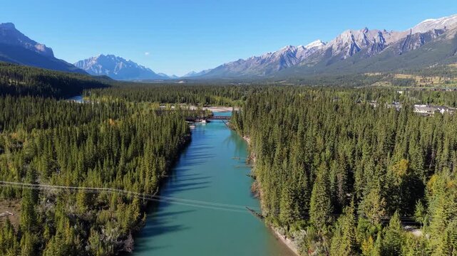Vast aerial view of Bow River winding through the Canadian Rockies. Canmore, Alberta, Canada.