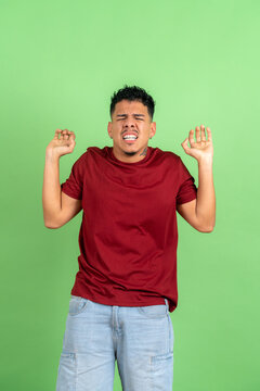 Young adult man expressing disgust, repulsion or disappointment