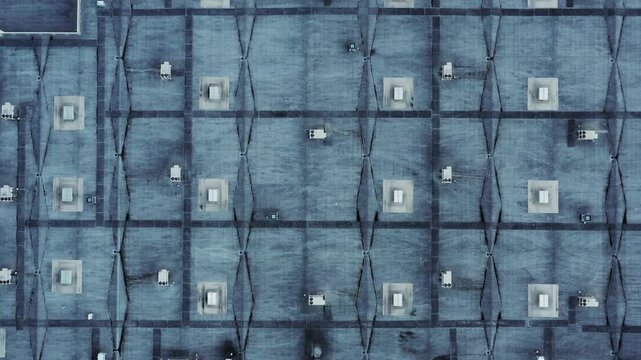 Aerial view of a flat industrial roof featuring a grid of HVAC units and ventilation systems in Russia.