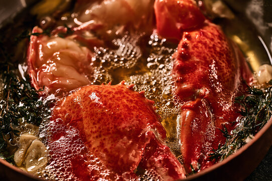 lobster claws gently poaching in a bath of bubbling golden butter
