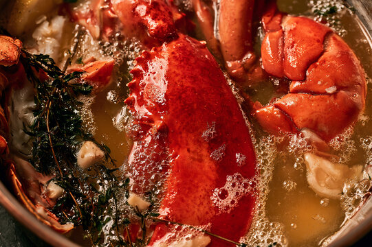 lobster claws gently poaching in a bath of bubbling golden butter