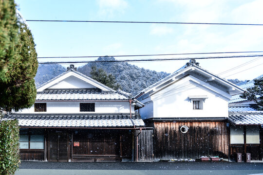 Traditional Japanese streetscape with lingering snow in winter