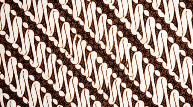 Traditional Indonesian Batik Pattern: A close-up view reveals the intricate and flowing white motif against a rich brown background, showcasing the detailed artistry of Indonesian batik.
