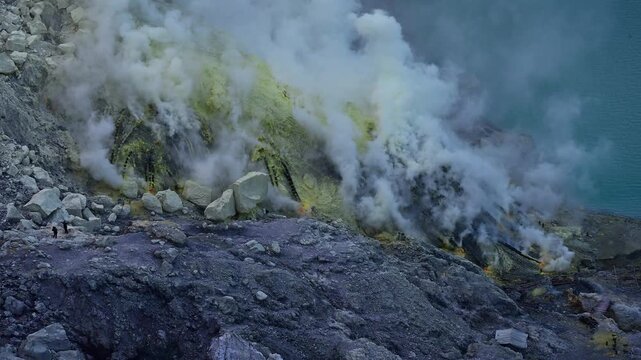Sulfur fumes from the crater of Kawah Ijen Volcano in Java island of Indonesia. This notorious sulphur mines are located down in the crater of the active volcano Kawah Ijen in East Java, Indonesia.