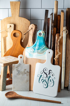 Stacks of various sizes and shapes of kitchen cutting boards.