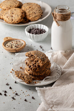 A stack of homemade quinoa chocolate chip cookies served with milk.