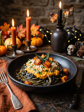Black pasta with pumpkin sauce and salmon, halloween theme