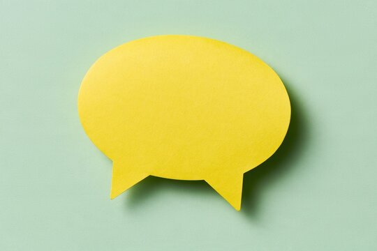 Yellow speech bubble on a light green textured background