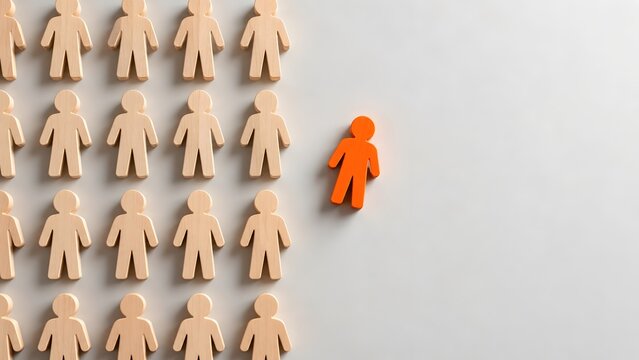 Unique orange wooden person figurine standing out from a group of natural wood figures
