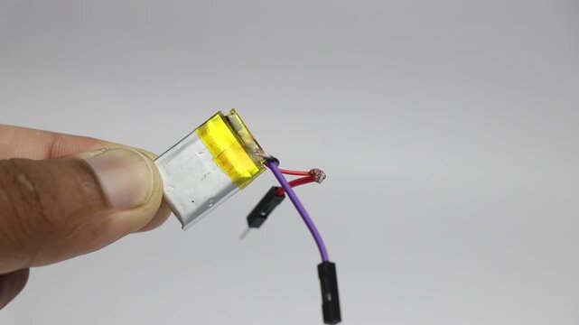 Small size lithium polymer battery with connector cable and pins held in the hand