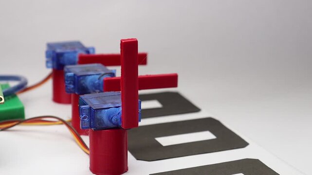 Plastic geared micro servo with 3d printed part attached on servo shaft close up view