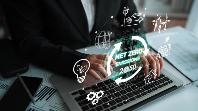 Business Professional Working on Laptop with Net Zero Emissions 2050 Concept and Eco-Friendly Icons for Sustainability and Environmental Goals. Entropy.