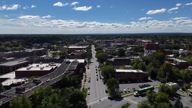 Downtown Saratoga Springs historic commercial district and main street architecture under a bright sunny sky with scattered clouds 4k aerial drone video