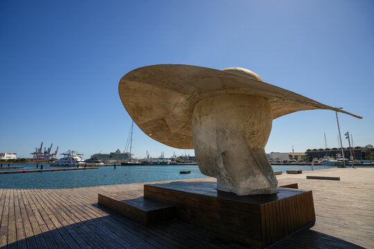 The monumental sculpture "La Pamela" by artist Manolo Valdes located at the Marina de Valencia marina in Valencia, Spain, under a clear blue sky.