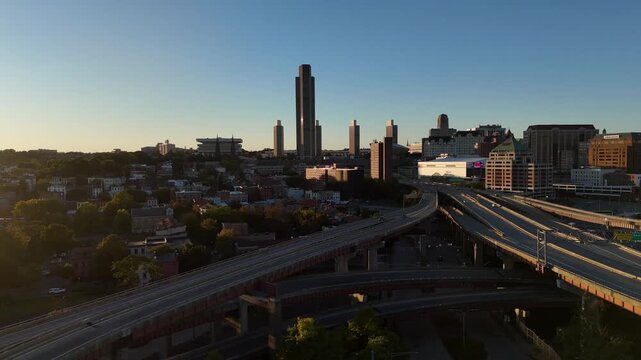 Downtown Albany New York skyline and highway interchange glowing in the warm light of a late afternoon sunset 4k aerial drone video