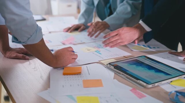 Business hands creating project financial charts and data mind map with colorful sticky notes