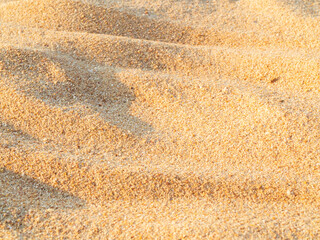 Naklejka premium Sand nature travel background, beach close up texture summer desert zen garden coast ocean for vacation, hot tropical scene nature, holiday dune pile dry brown heap