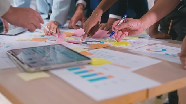 Business hands creating project financial charts and data mind map with colorful sticky notes