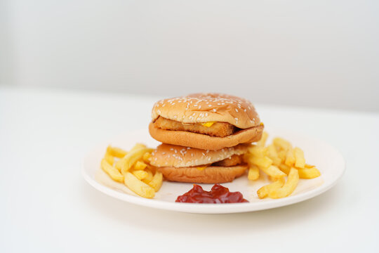 juicy beef burger with melted cheddar cheese, potato chips on table. Unhealthy, High calorie, Fast food craving, Obesity, diet, weight loss, junk food and lifestyle