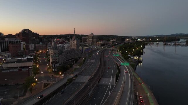 Interstate 787 running alongside the Hudson River and downtown Albany New York at twilight 4k aerial drone video