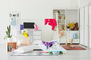 Childhood development and messy bedroom, disorganized kids room with toys and school supplies for home learning and creative play in a modern home © Pixel-Shot