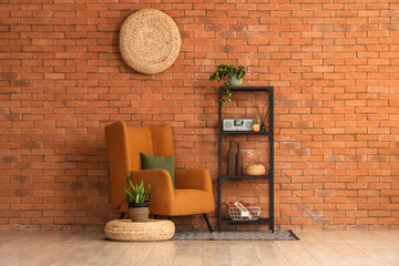 Interior design and home comfort, cozy reading nook with armchair and shelving unit against a rustic brick wall in a modern living room apartment © Pixel-Shot
