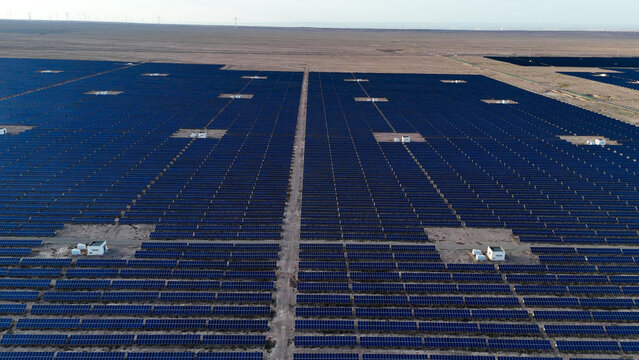 Aerial view of vast solar panel array in desert landscape