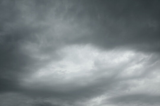Stormy weather and climate change, dark rain clouds gathering in the sky before a thunderstorm with heavy overcast atmosphere and gloomy mood