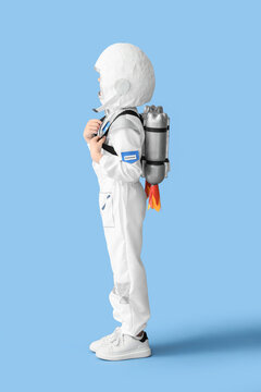Childhood imagination and future career dreams, young child wearing DIY astronaut costume with jetpack for space exploration play on blue background