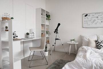 Stem education and scientific research, student bedroom with telescope and microscope for home learning and academic study in a modern white interior © Pixel-Shot
